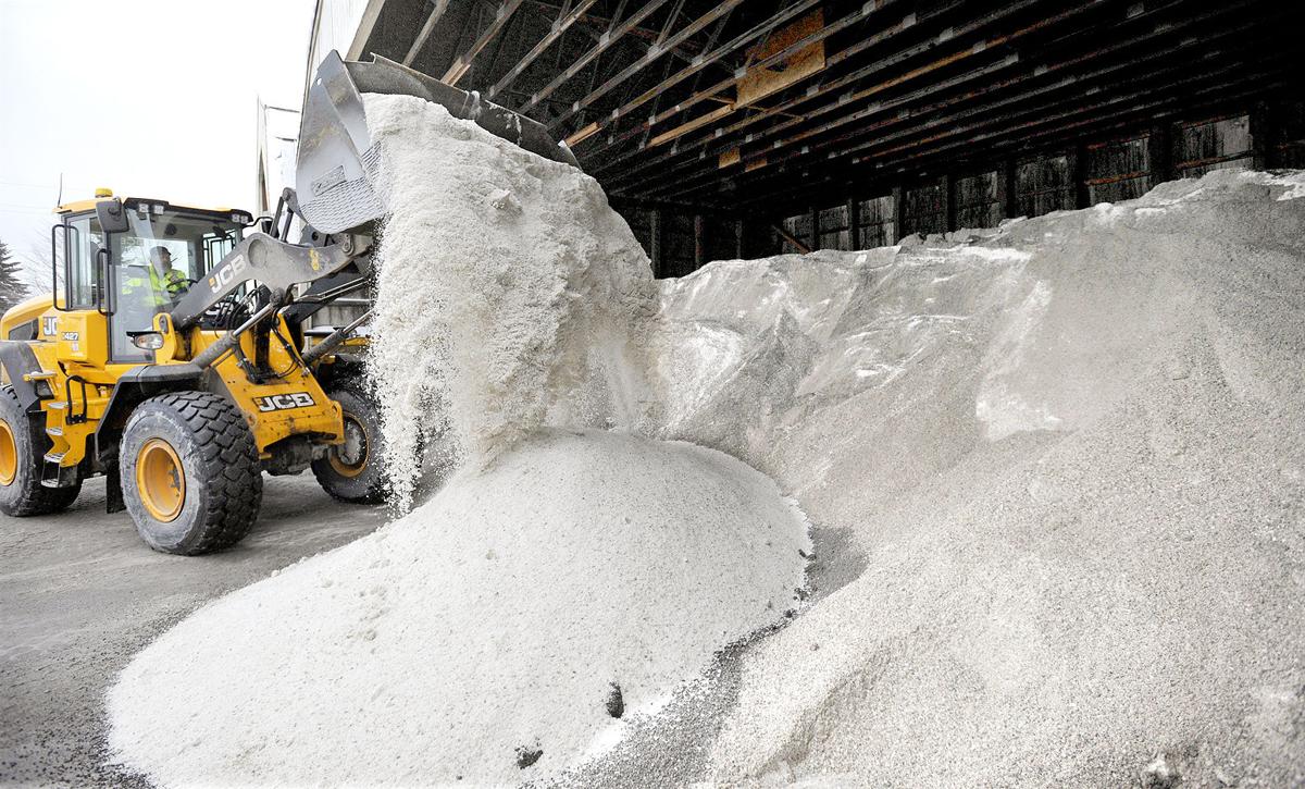 Front loader scooping winter road salt for maintenance work